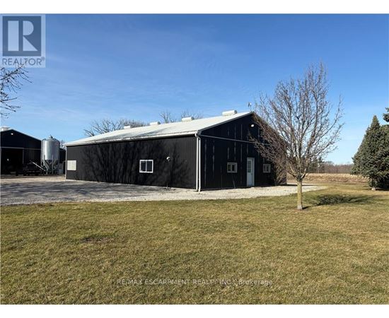 A barn with a tree in front of it.