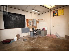 A room with a lot of debris and a fan on the floor.