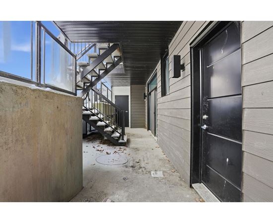 A black door is on the right side of a building.