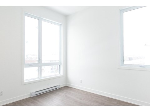 A room with a window and a wall-mounted air conditioner.