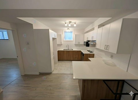 A kitchen with wooden cabinets and a white countertop.