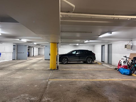 A black car is parked in a parking garage.
