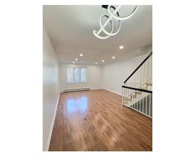 A room with wooden floors and a staircase.