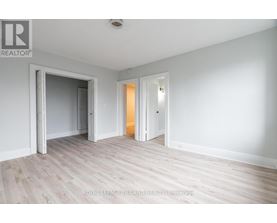 A white room with a doorway leading to another room.