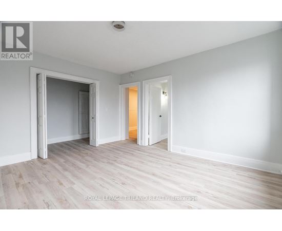 A white room with a doorway leading to another room.