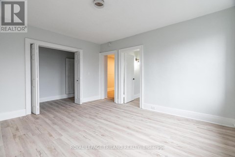 A white room with a doorway leading to another room.