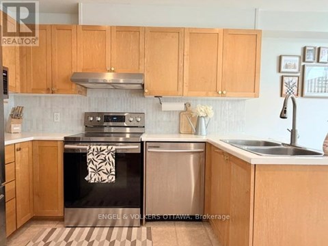 A kitchen with wooden cabinets and a black stove top oven.