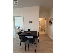 A dining room with a table and chairs.
