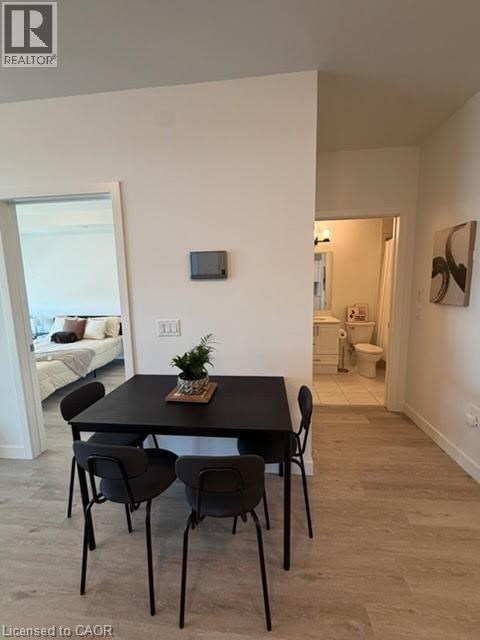 A dining room with a table and chairs.