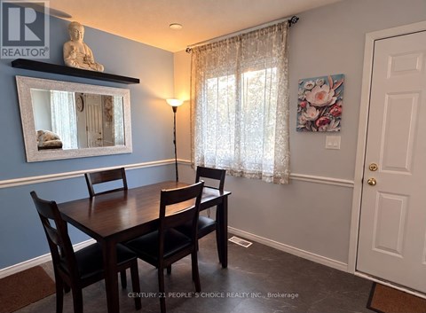 A dining room with a wooden table and chairs.