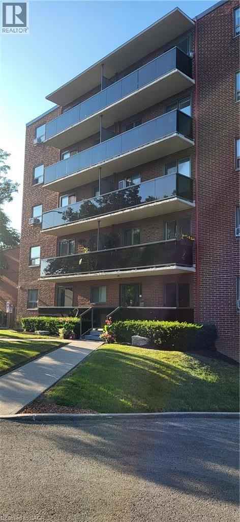 A red brick building with a balcony on the second floor.