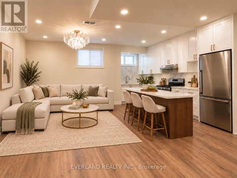 A modern kitchen with white cabinets and a wooden island.