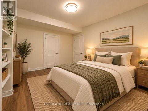 A bedroom with a large bed and a painting on the wall.