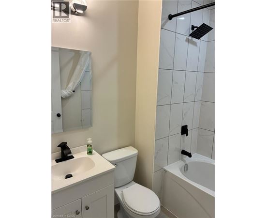 A white toilet sits next to a sink in a bathroom.