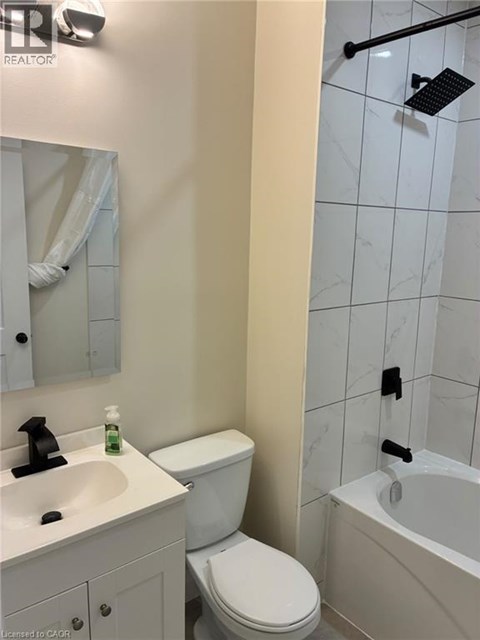 A white toilet sits next to a sink in a bathroom.