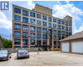 A large multi-story building with a parking lot in front.