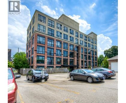 A parking lot with cars and a building with the logo REALTOR.