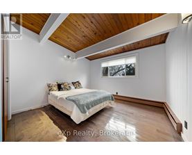 A bedroom with a bed and a window.