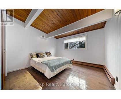 A bedroom with a bed and a window.