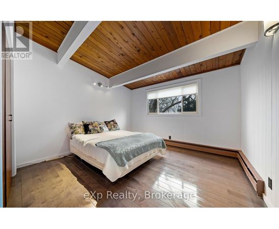 A bedroom with a bed and a window.
