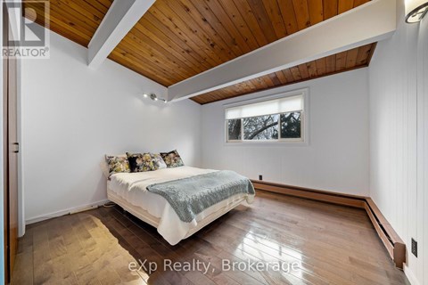 A bedroom with a bed and a window.