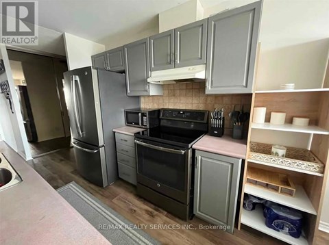 A kitchen with a black oven and microwave.