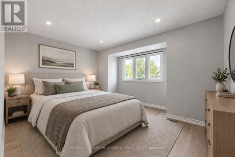 A bedroom with a large bed and a window.