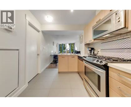A kitchen with a stove top oven and a microwave above it.