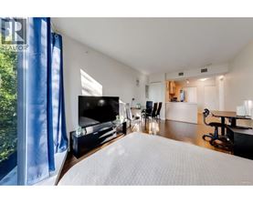 A bedroom with a large bed and a television.