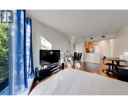 A bedroom with a large bed and a television.