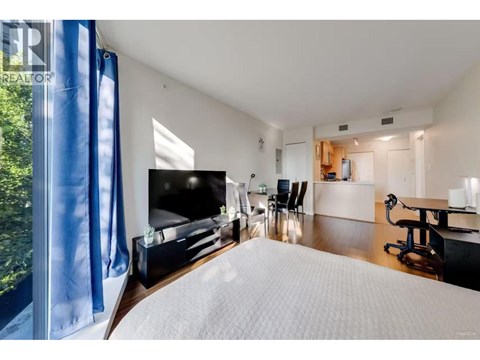 A bedroom with a large bed and a television.
