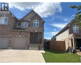 A house with a garage and a driveway in front of it.