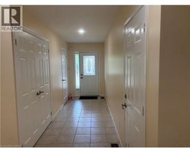 A hallway with white doors and a tiled floor.