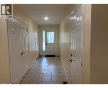 A hallway with white doors and a tiled floor.