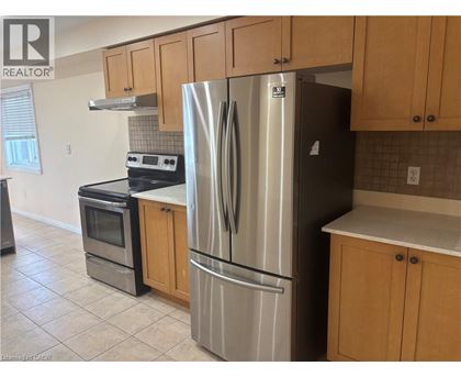 A kitchen with a stove, oven, and refrigerator.