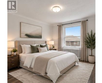 A bedroom with a large bed, a window with a view, and a painting on the wall.