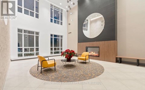 A living room with a fireplace and a yellow chair.