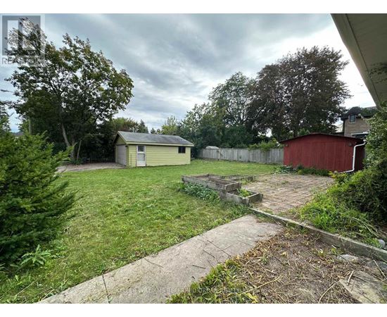 A backyard with a shed and a red barn.