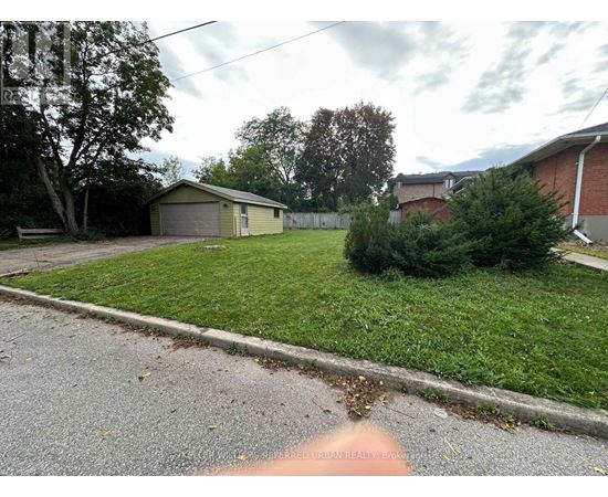 A residential area with a house, garage, and a tree.