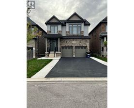 A house with a grey garage door and a driveway.