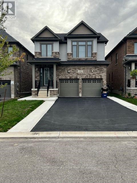 A house with a grey garage door and a driveway.