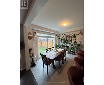 A dining room with a table and chairs.