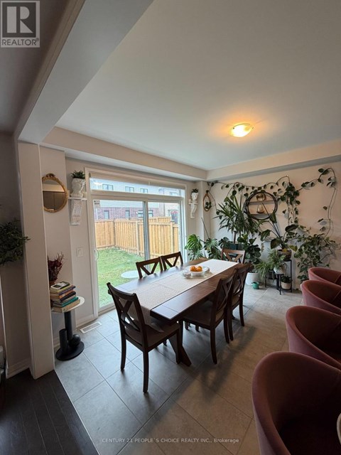 A dining room with a table and chairs.
