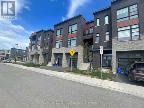 A street view of a residential area with apartment buildings and a car parked on the side of the road.