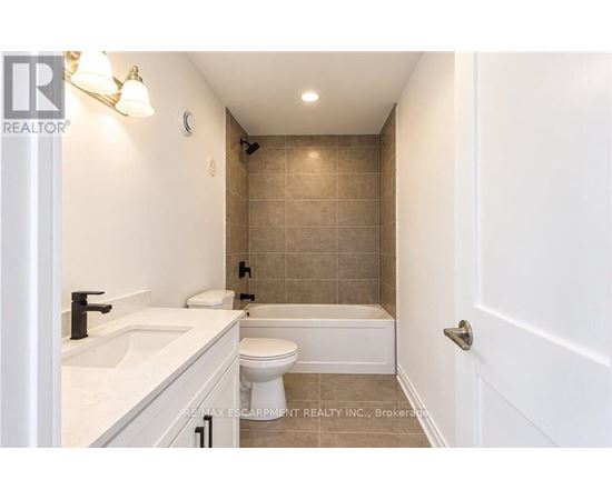 A bathroom with a toilet, sink, and bathtub.