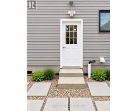 A white door is on the front of a house.