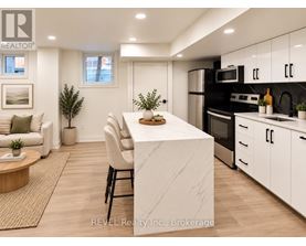 A modern kitchen with a white island and stainless steel appliances.