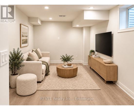 A living room with a couch, a coffee table, and a flat screen TV.