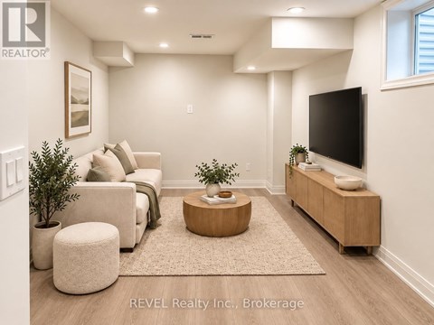A living room with a couch, a coffee table, and a flat screen TV.