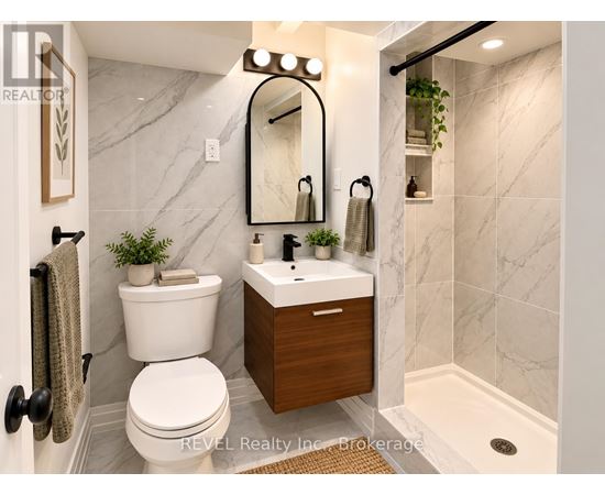 A bathroom with a white toilet and a marble wall.